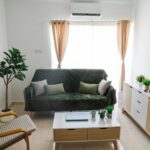 Simple-style living room featuring an armchair, grey sofa, coffee table, and living room cabinet